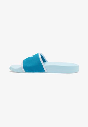 Blue slide sandal with a canvas upper, white trim, and a flat rubber sole. Features a simple design and open-toe construction.