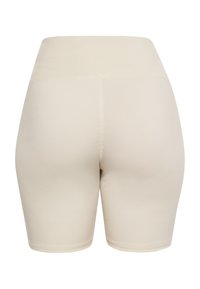 Beige korkeavyötäröiset shortsit, jotka on valmistettu joustavasta materiaalista. Ne sisältävät sileän pinnan ja siistin helman ilman näkyviä saumoja.