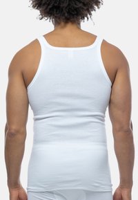 White cotton tank top, featuring a fitted design and wide shoulder straps. Smooth texture with no visible patterns or hardware accents.