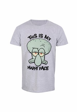 T-shirt en coton gris avec le visage d'un personnage de dessin animé et le texte "C'EST MON VISAGE HEUREUX" en grosses lettres noires en dessous.