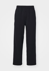 Sorte sweatpants med elastisk talje, lige ben og stikninger. Fremstillet af blødt, tekstureret stof.