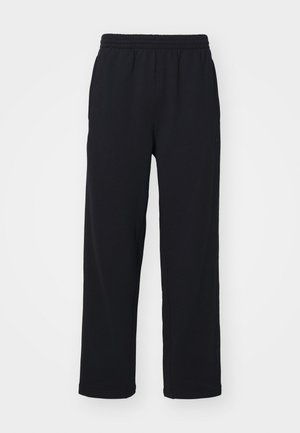Pantalones de chándal negros con cinturilla elástica, piernas rectas y detalles cosidos. Hechos de una tela suave y texturizada.