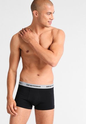 Fekete pamut boxer alsónadrág, szürke elasztikus derékrésszel, rajta az "Emporio Armani" logóval. Simaság és testhez simuló fazon jellemzi.