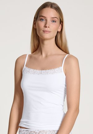 White camisole with lace trim along the neckline, thin straps, and a fitted design, made from soft, lightweight fabric.