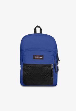 Sininen kangaskassi, jossa on musta verkko etutasku, kaksoisketjut ja yläkahva. Edessä on Eastpak-logo.