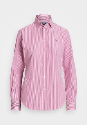 Röd- och vitrandig skjorta med knappar, långärmad, med krage och en liten blå logotyp. Tillverkad av ett slätt tyg med en klassisk passform.