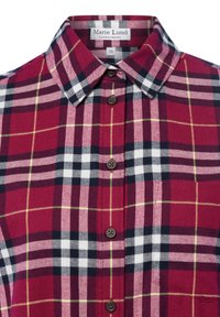 Red and navy plaid shirt with a classic collar, button front, and dark buttons. Fabric appears soft with a flannel texture.