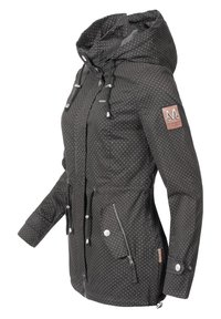 Black jacket with white polka dots, zippered pockets, drawstring hood, and adjustable cuffs. Features a branded patch on the sleeve.