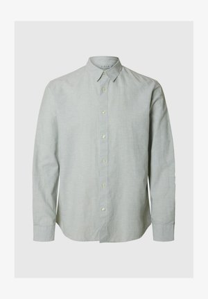 Hele roheline linane särk pikkade varrukatega, nupuga krae ja ees nupuga sulgemine. Sile tekstuur, tavaline lõige ja ümar serv.