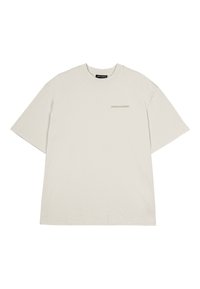 Camiseta de manga corta oversize beige con cuello redondo y pequeño logo "PEGADOR" impreso en marrón claro en el lado izquierdo del pecho.