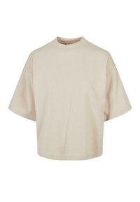 Světle béžové bavlněné tričko, krátké rukávy, stojáček, volný střih, hladká textura, minimalistický design bez vzorů nebo ozdob.