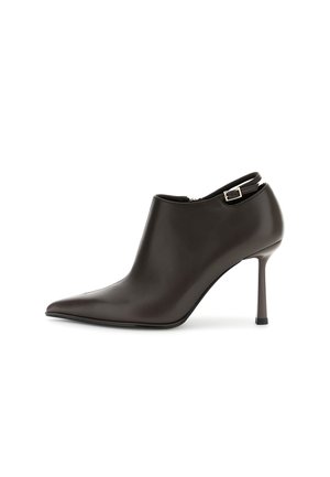Zwarte leren pumps met een puntige neus, een smalle naaldhak en een enkelbandje met een zilveren gesp.