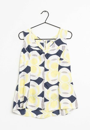 Blusa sin mangas con escote en V en percha negra con patrones circulares abstractos en amarillo, azul marino, gris y blanco sobre tela ligera.