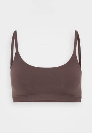 Bruine naadloze bralette met dunne verstelbare banden, ronde halslijn en een gladde matte textuur. Geen sluitingen of extra hardware zichtbaar.