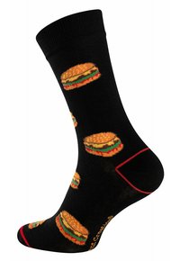 Chaussettes noires avec des graphiques répétés de hamburgers en orange, jaune, vert et rouge. Comprend un accent rouge le long du bord et un logo sur la semelle.