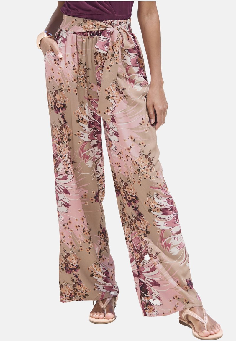 Flowy, wide-leg pants in beige with a pink floral pattern; features a tie waist and side pockets; lightweight, smooth fabric.