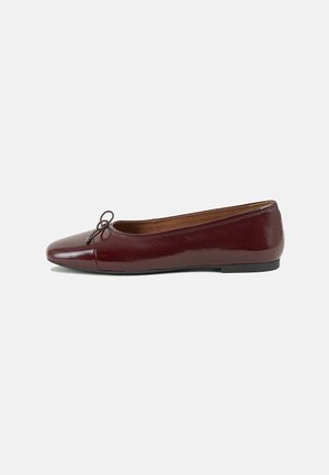 Burgundy patent leather ballet flat with a rounded toe, small bow accent at the front, and a low, black rubber sole. Smooth texture.