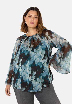 Luftige, durchsichtige Bluse in dunkeltürkis mit blau-weißen Blumenmuster. Verfügt über einen runden Ausschnitt und Schmetterlingsärmel, aus leichtem Stoff gefertigt.