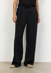 Black wide-leg pants with an elasticated drawstring waist, featuring subtle vertical seams and soft, smooth fabric texture.