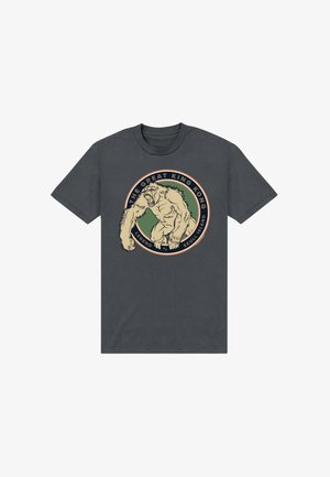 Mørkegrå t-shirt med en råbende King Kong illustration inde i en cirkulær ramme med tekst "The Great King Kong Legend of Skull Island."