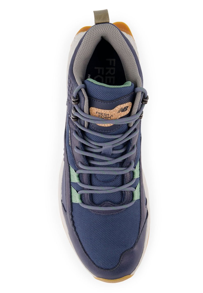 Marineblaue Sportschuhe aus Mesh und synthetischen Materialien. Merkmale sind hellgrüne Akzente, graue Schnürsenkel und eine strukturierte Gummisohle.