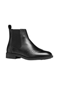 Botas Chelsea de cuero negro con paneles laterales elásticos, puntera redonda y detalles perforados en la puntera. Tacón de goma bajo.
