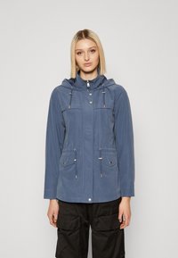 Blue lightweight jacket featuring a hood, front zip, two chest pockets, and side pockets with drawstring closures and silver accents.