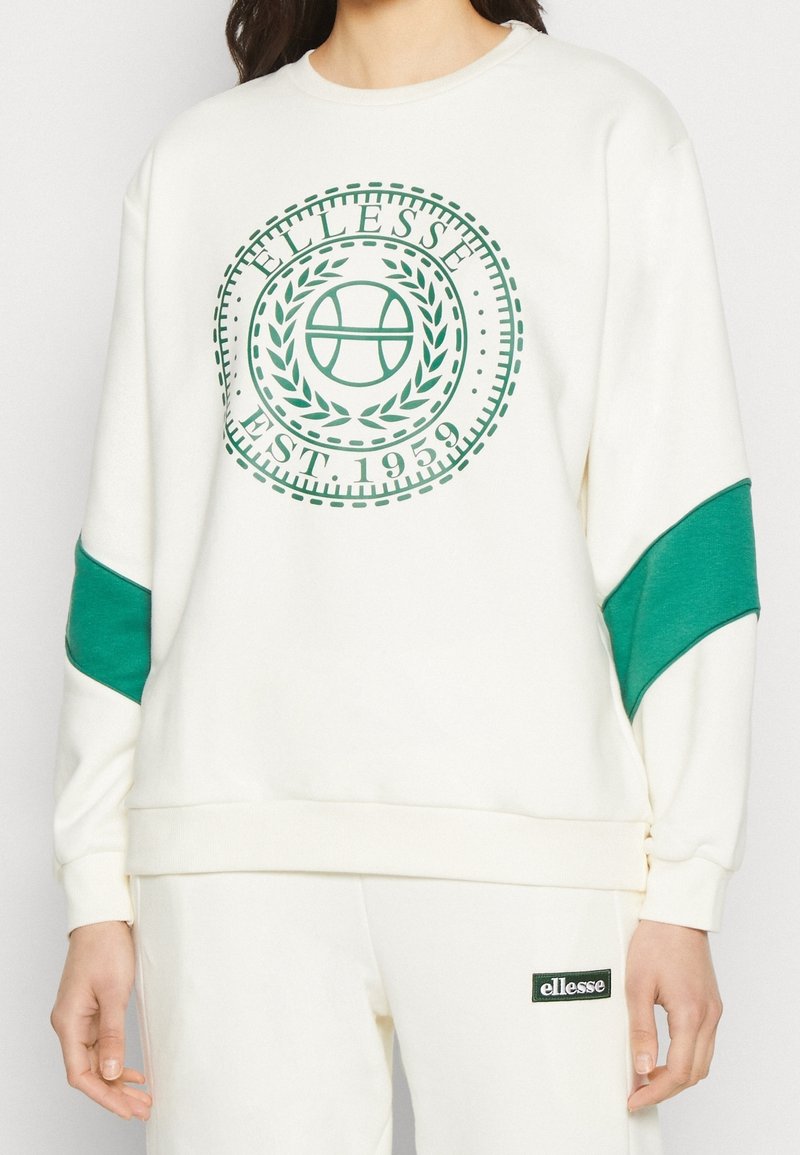 Felpa crema con un grafico verde a marchio e un design circolare, abbinata a dettagli verdi sulle maniche. Tessuto morbido.