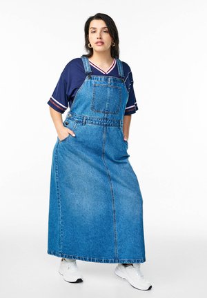 Denim maxi dress with adjustable straps, front pocket, and side pockets. Features a light blue wash and relaxed fit, suitable for casual wear.