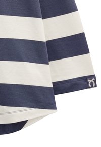 Koszulka w paski w kolorze granatowym i kremowym, z długimi rękawami i zaokrąglonym dołem. Materiał to miękka bawełna. Zawiera mały akcent w postaci kokardki na dolnej krawędzi.