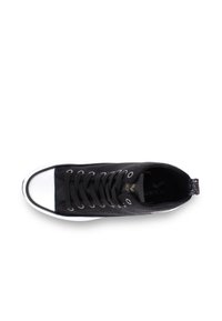 Black canvas sneaker with a white rubber toe cap, flat black laces, and a glittery pull tab on the heel. Features a textured surface.