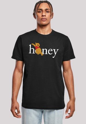 Black cotton t-shirt featuring a playful bear graphic and the word "honey" in white lettering. Classic crew neck design, relaxed fit.