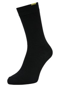 Schwarze Socke aus einem glatten, dehnbaren Stoff. Verfügt über einen gerippten Bund und einen kleinen gelben Akzent nahe der Oberseite. Klassisches Crew-Längen-Design.
