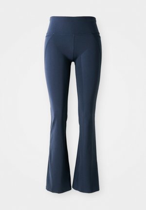 Pantaloni yoga svasati blu navy con un alto punto vita, realizzati in tessuto stretch morbido, con dettagli di cucitura lungo i lati.