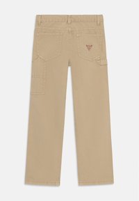 Beige cargos med rett snitt, baklommer og ekstra sidelommer. Har sømdetaljer og et lite logo merke.