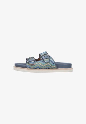 Blue and green woven slide sandal with two metallic buckle accents, smooth rubber sole, and a textured footbed for comfort.