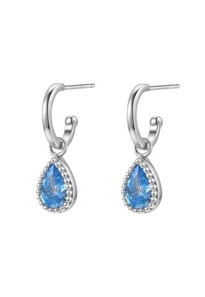 Silver hoop earrings feature a pear-shaped blue stone surrounded by a beaded accent. The overall polished finish adds a sleek look.