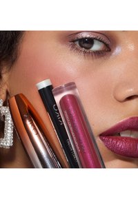 Cuatro productos de cosmética KIKO, incluyendo un tubo de máscara de pestañas en color rosa dorado, un lápiz rosa claro y dos pintalabios líquidos con brillo.