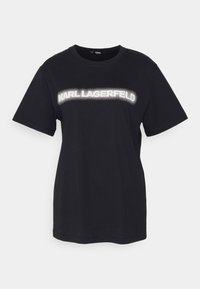 Camiseta de algodón negra de manga corta con el logo blanco y punteado de "Karl Lagerfeld" en el pecho. Ajuste simple y relajado.