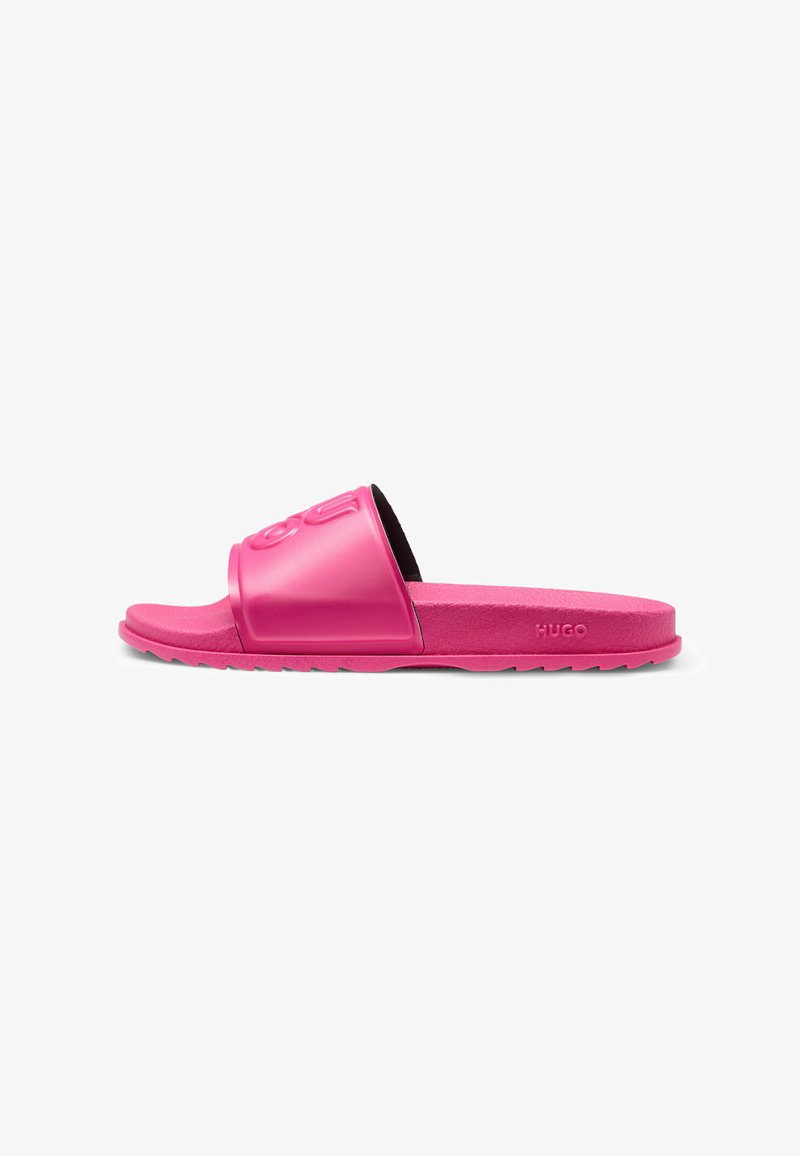 Pink slide sandals with a wide strap featuring embossed logo, flat textured sole, and durable material. Grey traction on the underside.