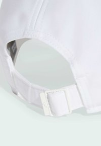 White cap featuring a smooth texture, adjustable strap, and plastic hardware for secure fastening. Stitching details visible along the edges.