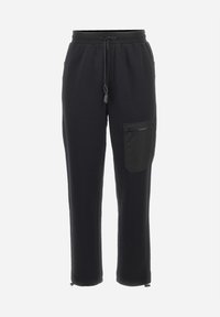 Zwarte joggingsbroek met een trekkoord in de taille, taps toelopende pijpen en een zijzak met ritssluiting. Gemaakt van zacht, gestructureerd materiaal.