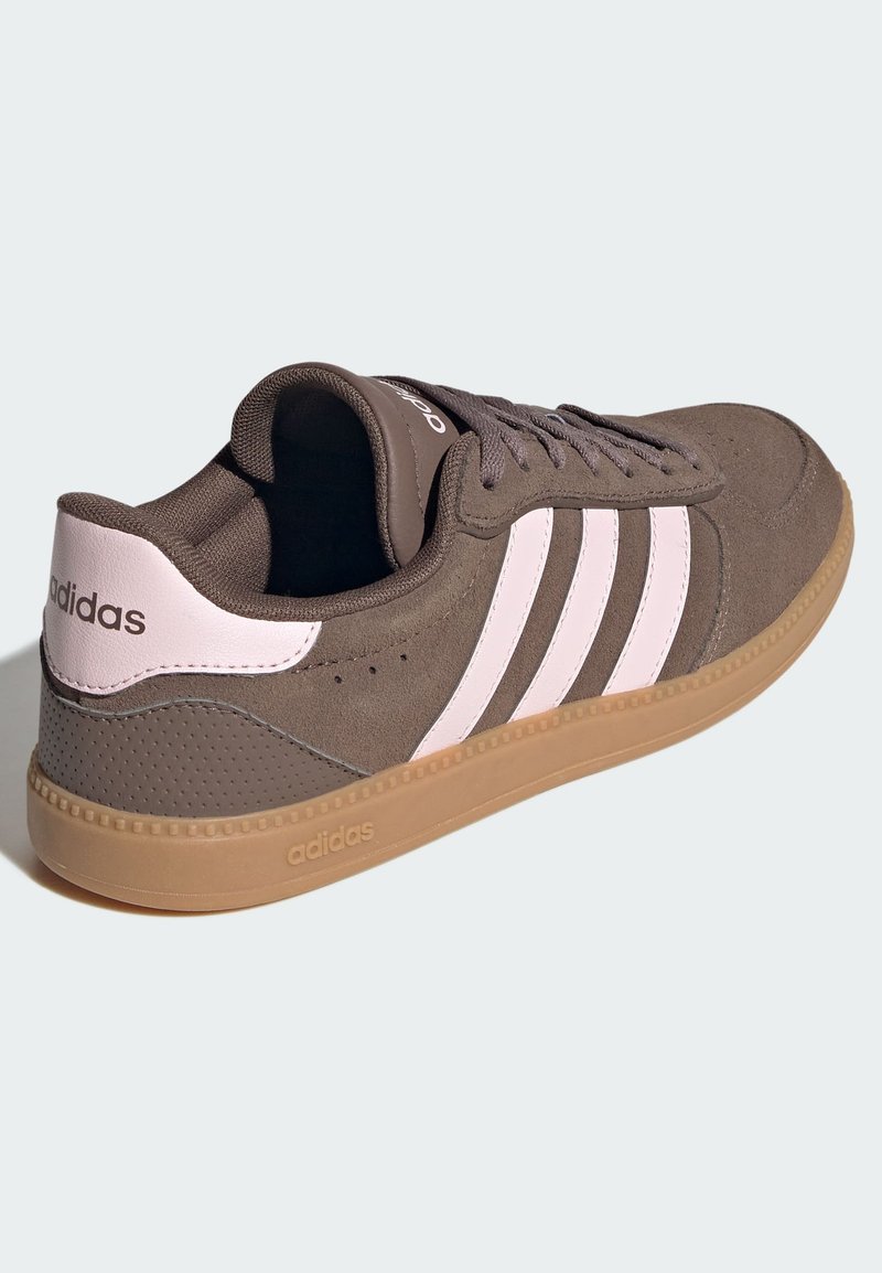 Brauner Wildleder-Sneaker mit glatten rosa Lederakzenten und drei weißen Streifen. Verfügt über eine Gummisohle in Kaugummi-Farbe und strukturierte Details am Obermaterial.