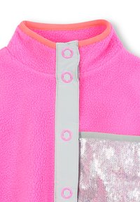 Bright pink fleece fabric with gray snap placket and pink accents; features a shiny, silver sequined pocket on the front.