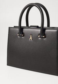 Black leather handbag with matte finish, gold hardware accents, structured shape, and two rounded handles. Notable gold bee emblem on front.