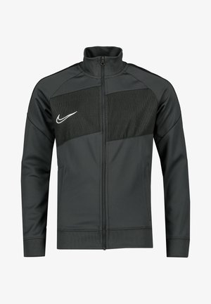 Giacca zip-up grigia scura realizzata in tessuto morbido con un pannello in rete sul petto, caratterizzata da un logo Nike bianco e tasche laterali.