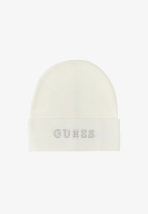 Kremo spalvos megztas kepurė su sulenktu kraštu, kuriame yra pilkai siuvinėtas "GUESS" logotipas. Minkšta tekstūra, apvalios formos.