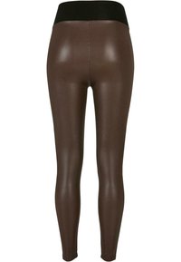 Braune Kunstlederleggings mit einem schwarzen Bund, die eine glatte, glänzende Textur und eine figurnahe Passform aufweisen. Keine sichtbaren Muster oder Beschläge.