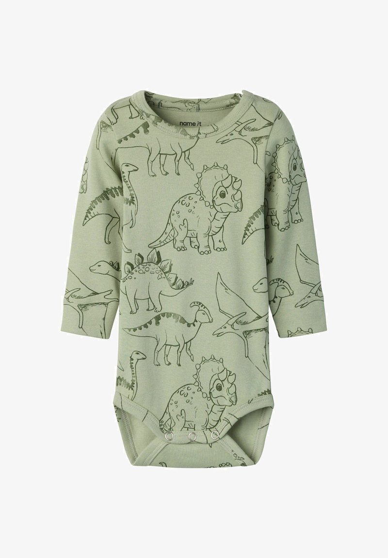Body bébé vert à manches longues avec illustrations de dinosaures en contour noir, y compris tricératops, stégosaure et ptérodactyle, fermetures à pressions en bas.