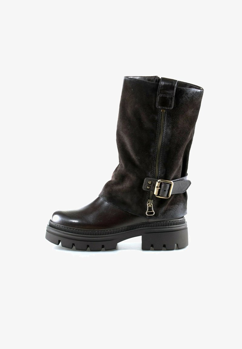 Botte noire mi-mollet avec semelle en caoutchouc épaisse, fermeture éclair latérale et sangle décorative avec boucle métallique sur fond blanc.